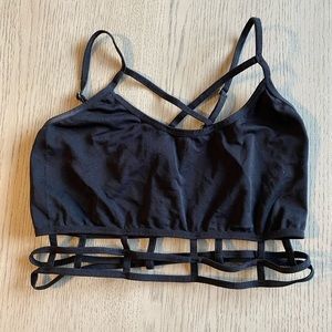 Black bralette with crossover front detail and strap details on bottom